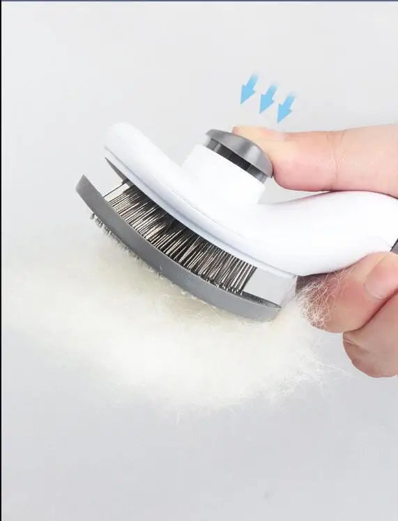 Pet grooming brush with gray and white body and metal pins, hand holding it on fur