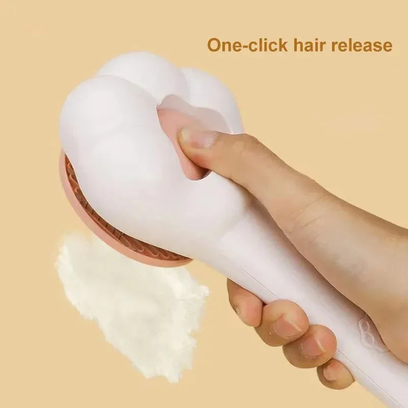 Pet grooming brush with white handle and pink pad; hair release shown