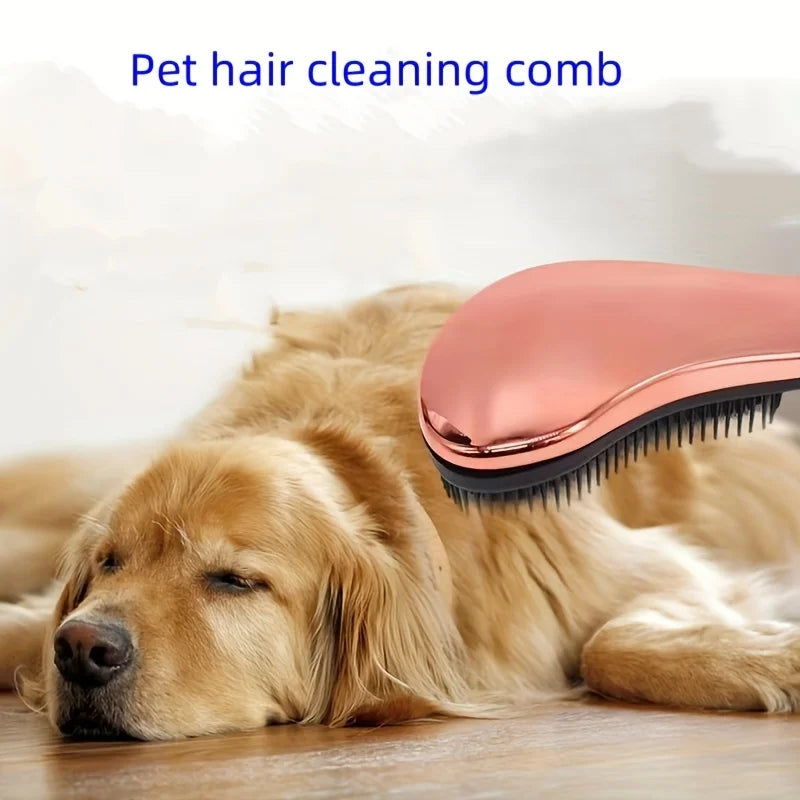 Pet hair cleaning comb with rose-gold body and black teeth, rounded pad design.