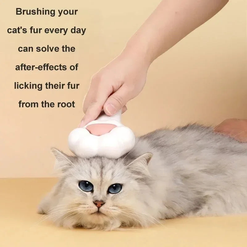 White pet grooming brush with pink paw comb head, brushing a fluffy cat