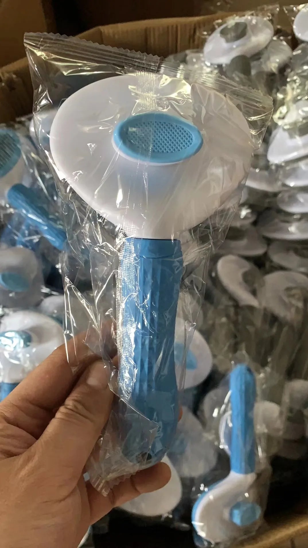 Blue stainless pet comb brush with round pin head and long handle in bag