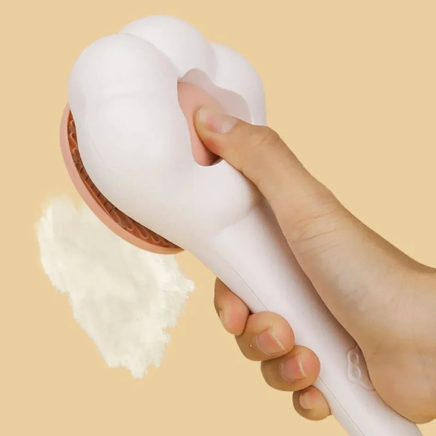 White pet grooming brush with pink pad; one-click hair release showing loose fur