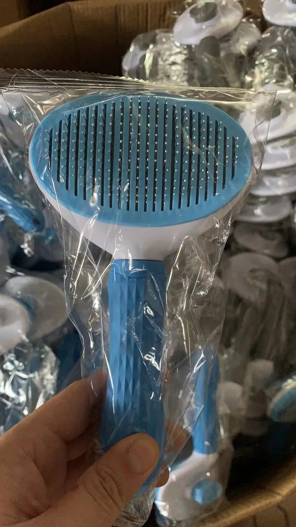 Blue stainless pet comb brush in plastic packaging, round pin head and handle