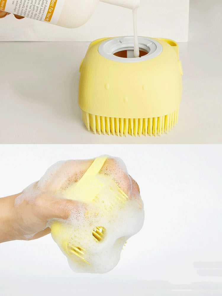 Yellow pet bath massage glove dispensing soap foam over a hand