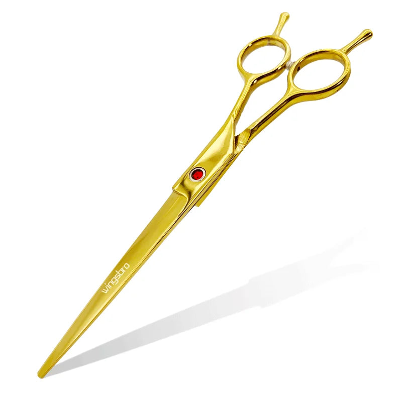 Gold grooming scissors with curved blades and two finger holes.