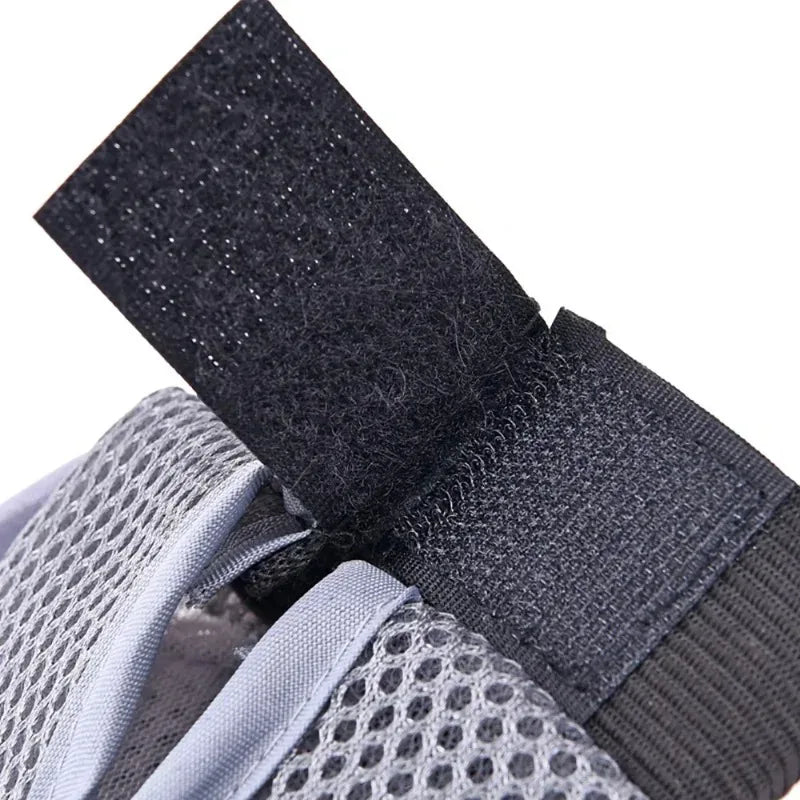 Grey pet grooming mitt with black strap and grey mesh panel over bristle bed
