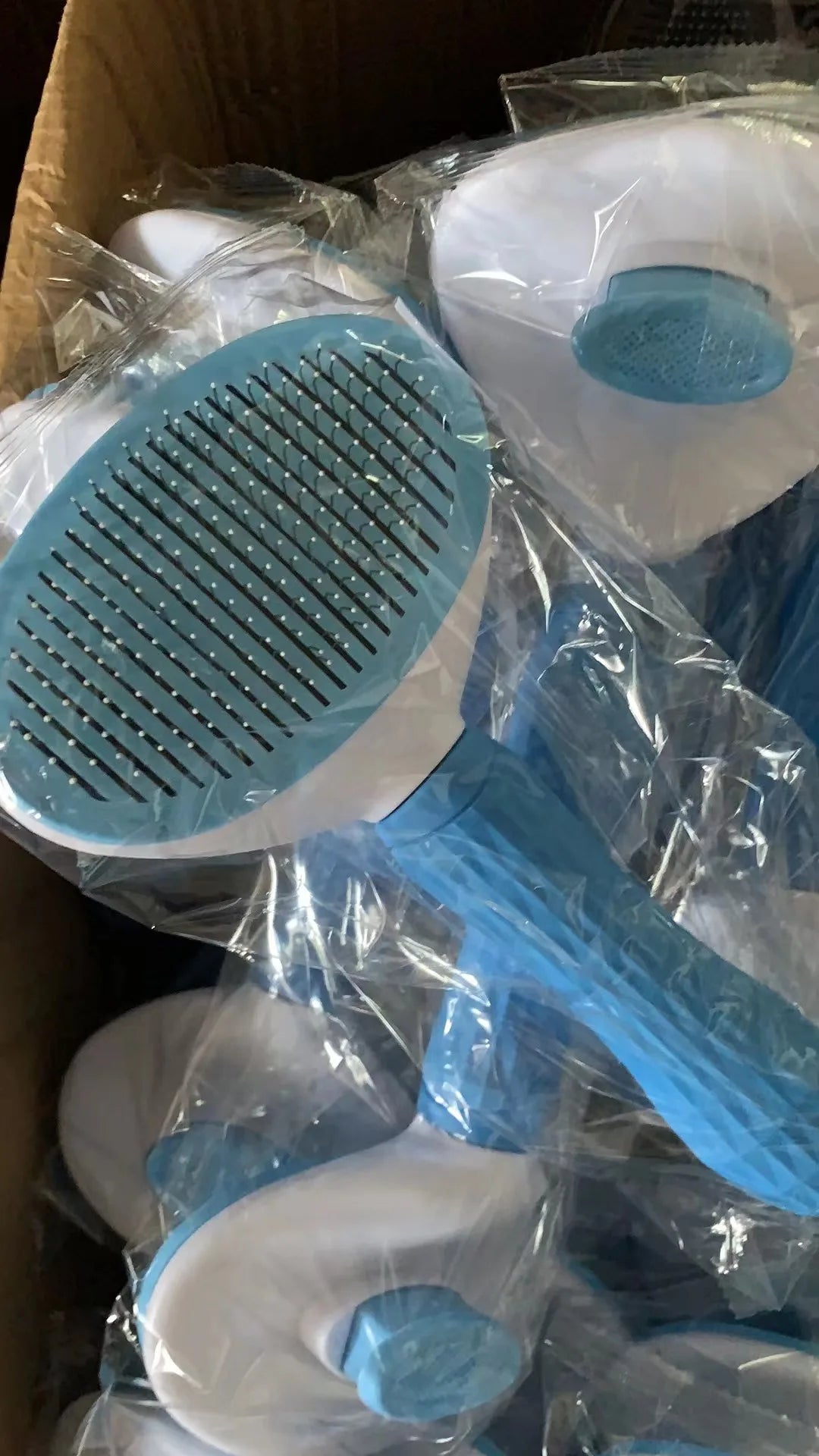 Blue pet comb grooming brushes, round pin heads with long handles in packaging